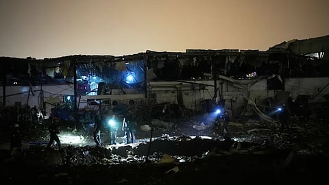 Israeli security forces and rescue teams inspect a site struck by an Iranian missile in Petah Tikva, Israel