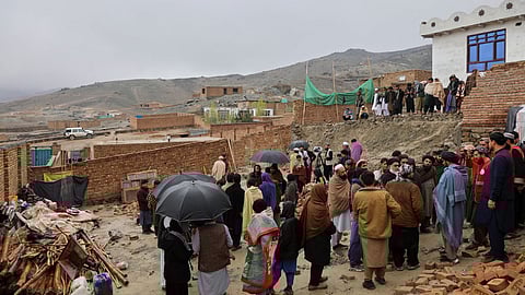 Locals and journalists inspect a house damaged by an earthquake in the village of Ittefaq, on the outskirts of Kabul, Afghanistan, Saturday, April 4, 2026.