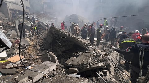 Rescue workers search for victims at the site of an Israeli airstrike that hit a crowded neighbourhood south of Beirut, Lebanon