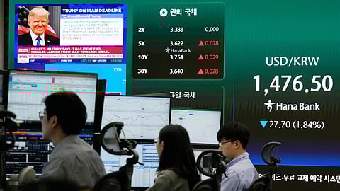   U.S. President Donald Trump is seen on a screen as traders work at the foreign exchange dealing room of the Hana Bank headquarters in Seoul, South Korea, Wednesday, April 8, 2026.
