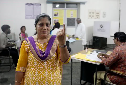 People show their ink-marked fingers after casting votes during the Puducherry Assembly elections, at a polling station in Puducherry, Thursday, April 9, 2026.