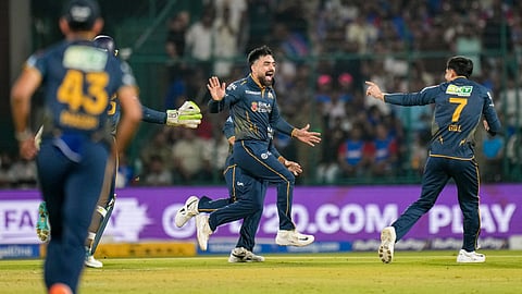 Gujarat Titans' Rashid Khan celebrates after dismissing Delhi Capitals' Sameer Rizvi with captain Shubman Gill, right, during an Indian Premier League (IPL) 2026 T20 cricket match between Delhi Capitals and Gujarat Titans, at Arun Jaitley Stadium, in New Delhi, Wednesday, April 8, 2026 