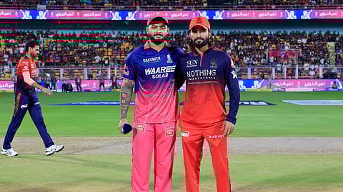 Rajasthan Royals captain Riyan Parag with Royal Challengers Bengaluru skipper Rajat Patidar during the toss