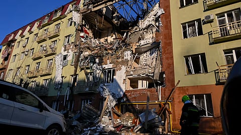 A rescue worker walks in front of residential building which was heavily damaged after a Russian strike in Odesa