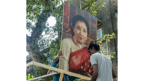 Workers decorate a vehicle for carrying the mortal remains of singing legend Asha Bhosle, in Mumbai, Maharashtra, Monday, April 13, 2026. The 92-year-old singer passed away on Sunday due to multi-organ failure 
