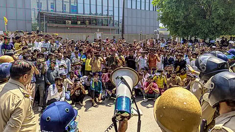 Factory workers during a protest demanding a hike in wages, in Noida, Gautam Buddh Nagar district, Uttar Pradesh