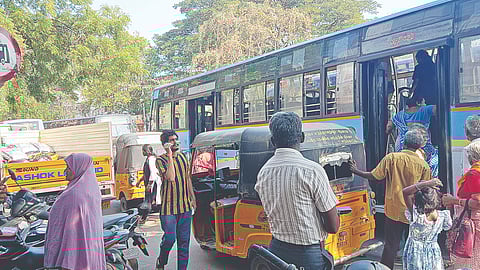 Commuters struggle to board buses as vehicles are parked at the designated shelter