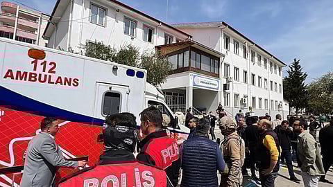 Turkish security forces and emergency staff stand in the courtyard of a secondary school where an assailant opened fire, in Kahramanmaras, Turkey