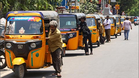Autos waiting in a queue to fill gas