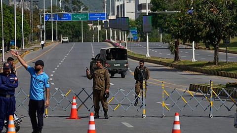 Police officers stand guard at a checkpoint ahead of the second round of negotiations between the U.S. and Iran, in Islamabad, Pakistan