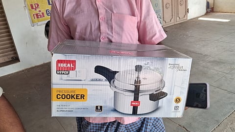 Election officials with a cooker seized in Krishnarayapuram on Wednesday 