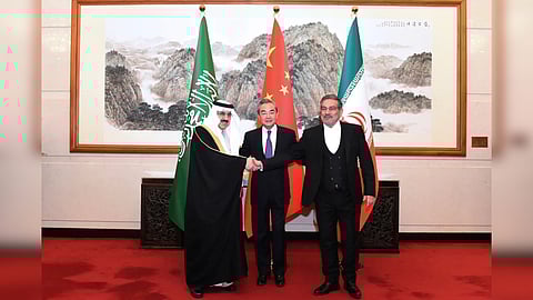 Photo released by Xinhua News Agency, Ali Shamkhani, then secretary of Iran's Supreme National Security Council, right, shakes hands with Saudi national security adviser Musaad bin Mohammed al-Aiban, left, as Wang Yi, China's most senior diplomat, looks on for a photo during a closed meeting held in Beijing.