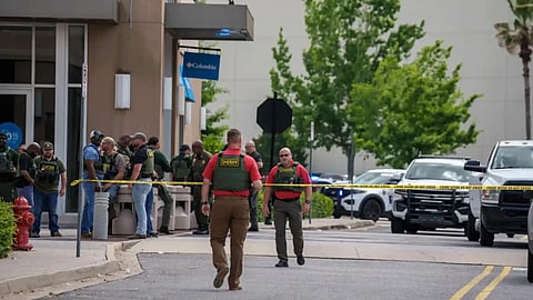 Law enforcement personnel respond to reports of a shooting at Mall of Louisiana in Baton Rouge, La