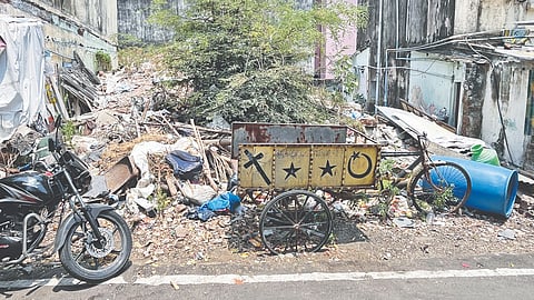 Uncleared construction debris piled up between housing board flats at Boopathy Nagar in Kodambakkam 
