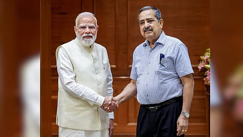 Prime Minister Narendra Modi, left, exchanges a handshake with newly-appointed Vice Chairman of Niti Aayog Ashok Lahiri.