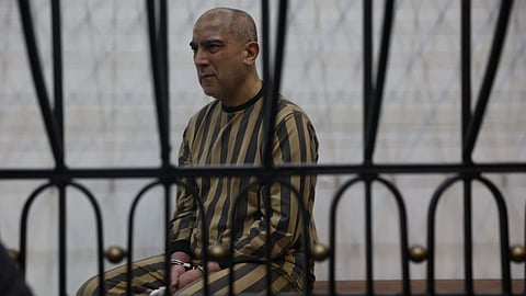 Atef Najib, former head of the Political Security Branch in the Daraa area during Bashar Assad's rule, sits in the defendants' cage during a trial session at the Palace of Justice in Damascus, Syria