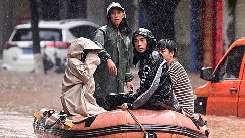 Residents are evacuated on a boat after flooding from heavy rainfall in Qinzhou in southern China's Guangxi Zhuang Autonomous Region on Monday, April 27