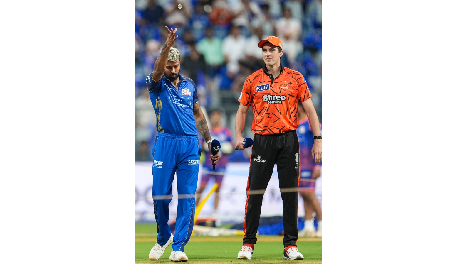 Mumbai Indians' captain Hardik Pandya, left, flips the coin as Sunrisers Hyderabad's captain Pat Cummins takes the call during the toss before an Indian Premier League (IPL) 2026 T20 cricket match between Mumbai Indians and Sunrisers Hyderabad, in Mumbai, Maharashtra, Wednesday, April 29, 2026.