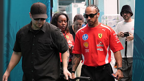 Ferrari driver Lewis Hamilton, center right, of Britain, leaves a hospitality tent after speaking to the press, Thursday, April 30, 2026, in Miami Gardens, Fla., ahead of the Formula One Miami Grand Prix auto race