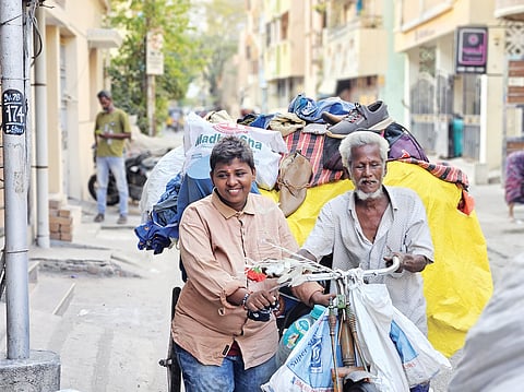 An elderly cycle cart puller hauls house-shifting loads
