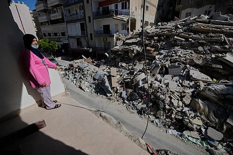 Em Ali Khodor, 75, looks through her damaged apartment hit a few weeks ago by an Israeli airstrike in Tyre, Lebanon.