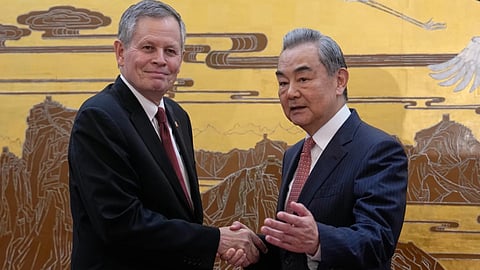 US Senator Steve Daines, left, is greeted by Chinese Foreign Minister Wang Yi during a US congressional delegation visit at the Great Hall of the People, in Beijing