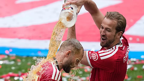 Bayern's Harry Kane, pours beer on Bayern's Joshua Kimmich as they celebrate the Bundesliga title at the end of the soccer match between Bayern and FC Cologne
in Munich, Germany, Saturday, May 16, 2026. 