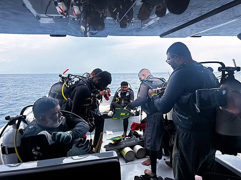 This image released by the Maldives President’s Media Division, shows divers preparing to search for the four missing Italian divers near Alimathaa Island