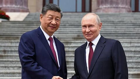 Russian President Vladimir Putin, right, and Chinese President Xi Jinping shake hands during a welcome ceremony at the Great Hall of the People, in Beijing, China