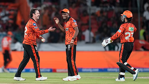 Sunrisers Hyderabad's Travis Head, left, celebrates with teammate Sakib Hussain after taking the wicket of Royal Challengers Bengaluru's captain Rajat Patidar during the Indian Premier League