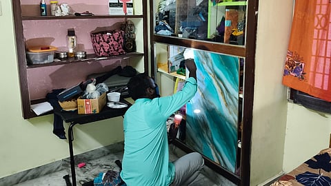 A fingerprint expert collects evidence at the house where the latest robbery took place