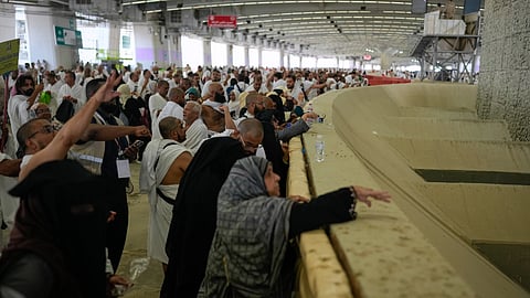 Muslim pilgrims pray after they cast pebbles at pillars in the symbolic stoning of the devil, the last rite of the annual Hajj, in Mina near the holy city of Mecca, Saudi Arabia, Wednesday, May 27, 2026.