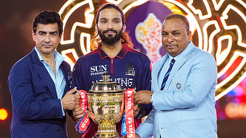 BCCI President Mithun Manhas, left, and Secretary Devajit Saikia, right, hand over the tournament trophy to Royal Challengers Bengaluru's captain Rajat Patidar during the presentation ceremony after winning the Indian Premier League