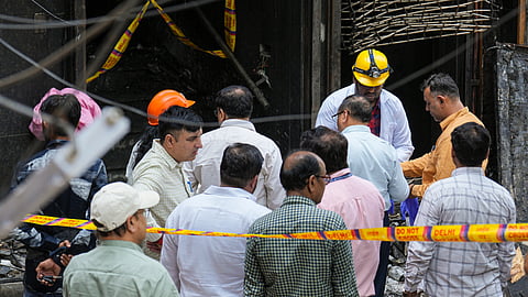 Forensic officials at the site after a fire broke out at a bed-and-breakfast in a five-storey building in south Delhi's Malviya Nagar area