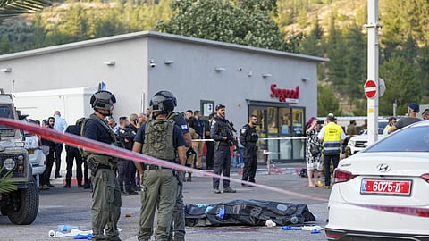 Israel's police standing next to the body of the attacker 