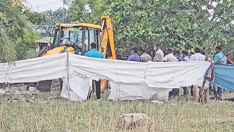 Police and officials from Revenue department exhume the boy's body in Tiruttani on Thursday 