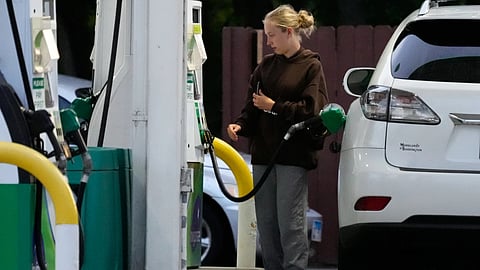 Customer checks gas price before she fills up her vehicle's tank at a gas station in Lincolnshire