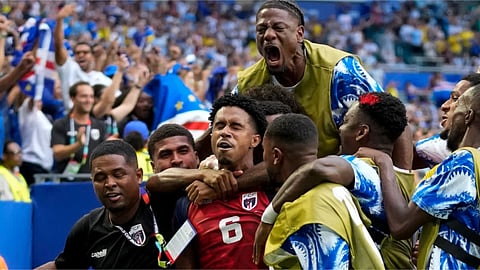 Cape Verde's Kevin Pina, center, celebrates with teammates after scoring the opening goal during the World Cup Group H soccer match between Uruguay and Cape Verde in Miami Gardens