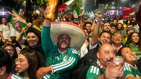 Mexican fans celebrate after beating South Korea during the World Cup Group A soccer match, at the Angel of Independence monument in Mexico City