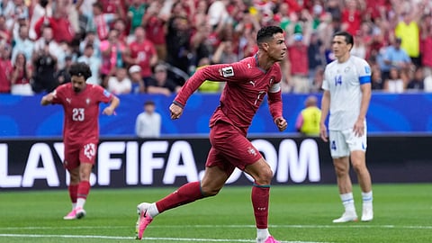 Portugal's Cristiano Ronaldo celebrates after scoring the opening goal during the World Cup Group K soccer match between Portugal and Uzbekistan in Houston