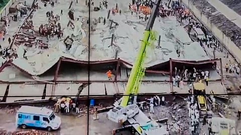 Officials conduct a rescue operation after a three-storey under-construction warehouse collapsed at Taratala area, in Kolkata