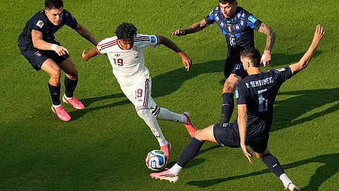 Spain's Lamine Yamal (19) controls the ball against Uruguay's Mathias Olivera (16), Rodrigo Bentancur (6) and Manuel Ugarte (5) during the World Cup Group H soccer match between Uruguay and Spain in Zapopan, near Guadalajara, Mexico.