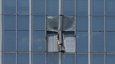 A section damaged after a small plane crashed into it is boarded up at the CITIC Tower, also known as China Zun, the tallest building in Beijing
