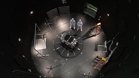 This photo provided by NASA shows Kieran Wilson, LINK’s principal investigator, and Hunter Robertson, a space systems engineer, both at Katalyst Space, standing next to their spacecraft inside the SES (Space Environment Simulator) at NASA’s Goddard Space Flight Center in Greenbelt, Md., April 17, 2026, ahead of thermal vacuum testing. 