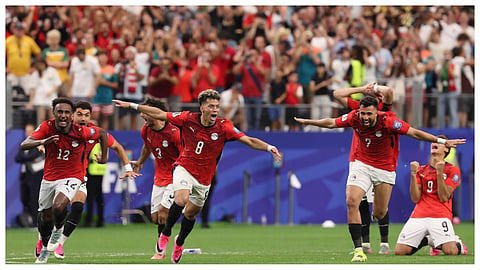 Egypts players celebrate after their teammate Hossam Abdelmaguid (4) score the winning penalty during World Cup round of 32 soccer match between Australia and Egypt in Arlington, Texas, near Dallas.