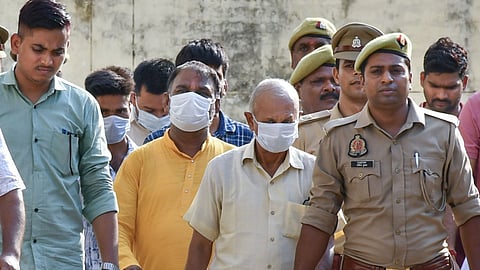 Ayodhya: Police personnel escort accused to a court in connection with the alleged embezzlement of Ram Temple donation funds, in Ayodhya, Friday, June 26.