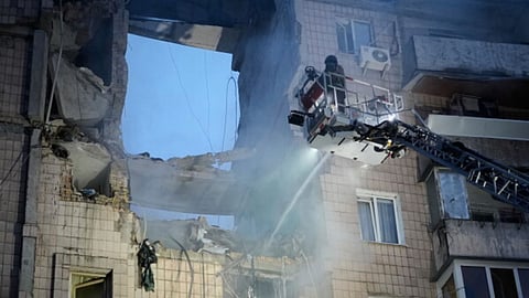Rescuers work the scene of a building damaged by Russian missile attack in Kyiv, Ukraine.