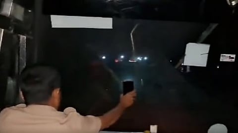 The conductor held a mobile torch to help the driver navigate.