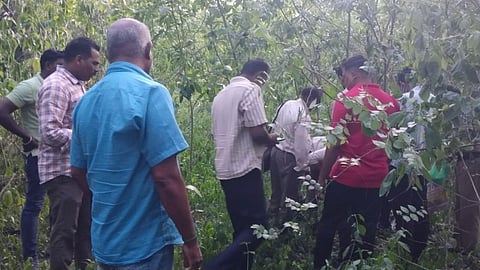 Police and public at the site to retrieve the bodies from the well