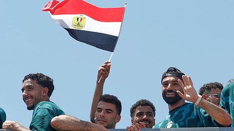 Mohamed Salah, right, smiles as he is greeted by fans upon the Egyptian national soccer team arrival at El-Alamein airport, 160 km (99 miles) west of Alexandria, Egypt.